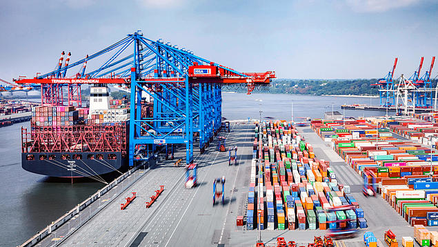 Aerial view of HHLA Container Terminal Burchardkai in Hamburg with container cranes, block storage and moving van carriers (VCs).