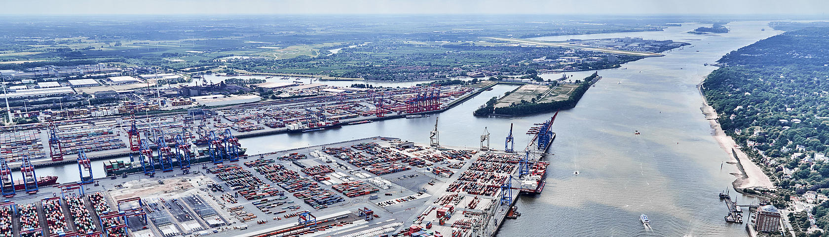 Aerial view of the HHLA Container Terminal Burchardkai (CTB) in Hamburg with block storage, container gantry cranes and van carriers (VCs) in operation.